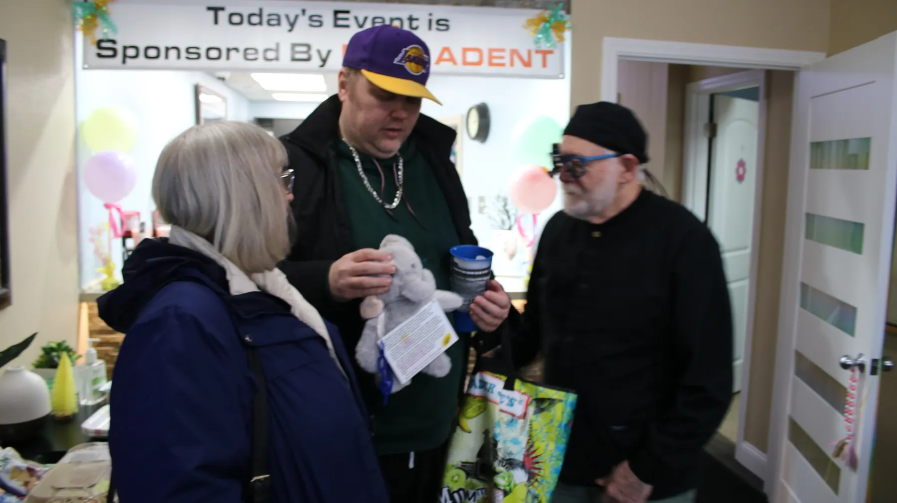 A guest receiving a gift during Special Needs Day of Dentistry